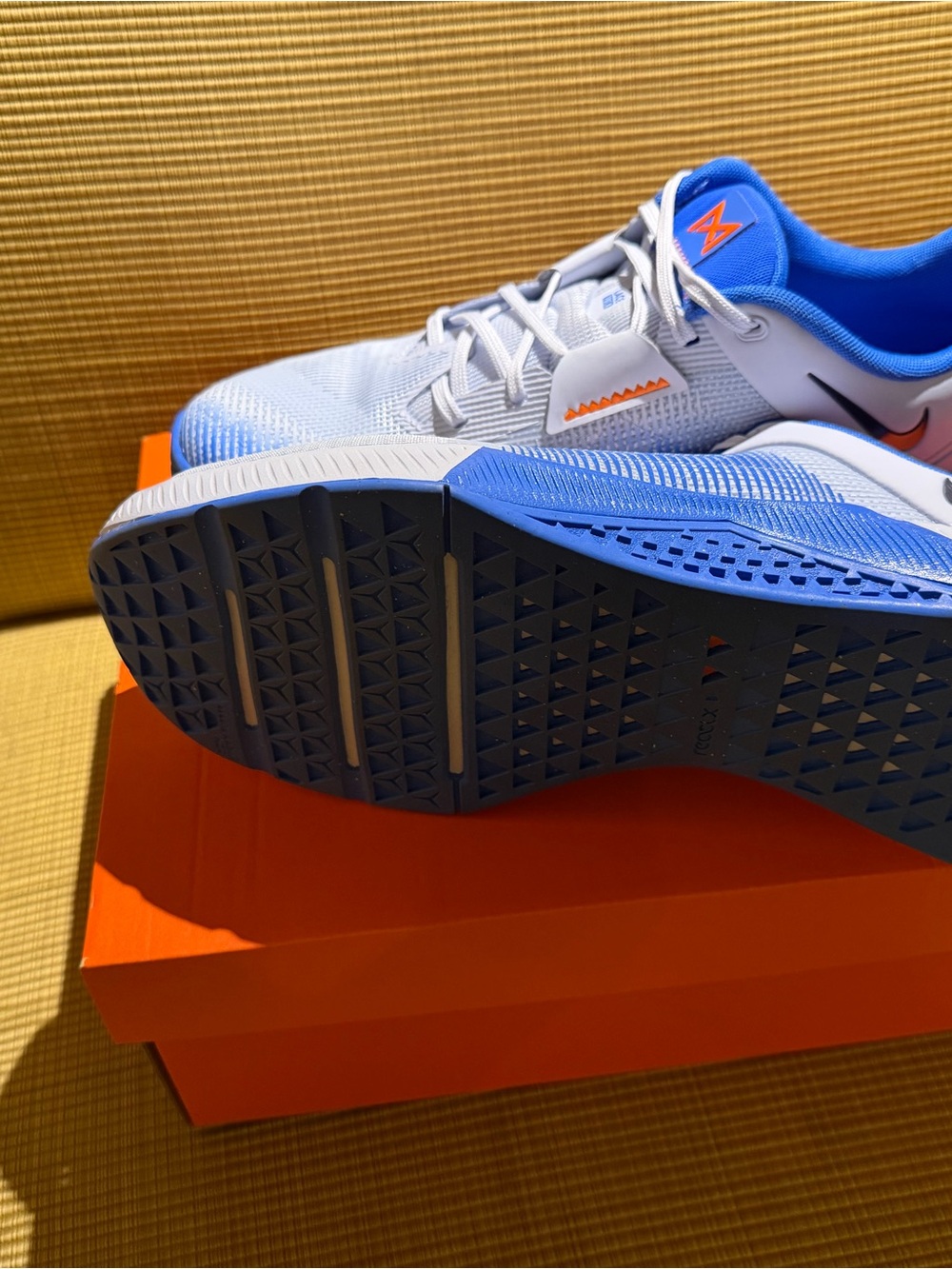 Nike Men’s White and Blue Training Shoes with Orange Accent